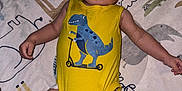 Branson is registered to the contest to win money with this photo: baby, infant, yellow_onesie, dinosaur_print, blanket, animal_pattern, lying_down, cute, child, indoor, soft_toys, pacifier, playmat, young_child, skin, head, arms, legs, expression, comfort