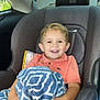 Bryson joined the competition — help win amazing prizes! child, car_seat, blanket, smiling, happy, indoors, seatbelt, clothing, short_sleeve, car_interior, window, daylight, young_child, hair, face, person, seat, safety, comfort, casual