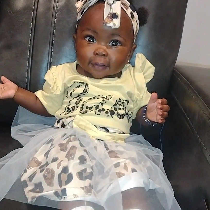 Kaliyah joined the competition — help win amazing prizes! accessories, baby, chair, clothing, couch, cushion, dress, face, footwear, furniture, head, homedecor, hosiery, person, photography, portrait, shoe, sitting, sneaker, sock