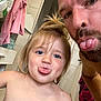 child, man, tongue, bathroom, selfie, playful, blue_eyes, hair, skin, face, person, tile, cabinet, towel, shirt, expression, humor, indoors, family, fun