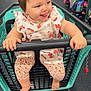 toddler, child, shopping_cart, store, aisle, clothing, smile, happy, cute, baby, footwear, patterned_clothes, plastic_cart, handrail, retail, shopping, playful, floor, indoor, person