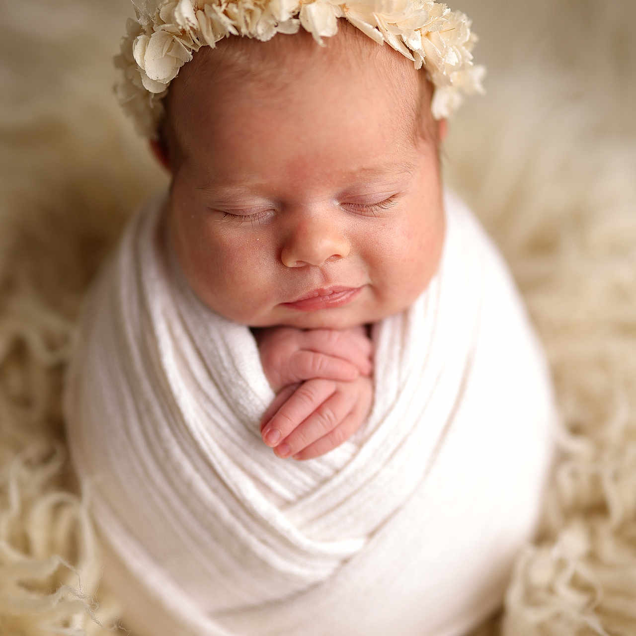 Tiffani participe au concours pour gagner de l'argent avec cette photo : newborn, baby, sleeping, wrapped, blanket, headband, flower_crown, soft_texture, cozy, infant, portrait, cute, peaceful, hands, closeup, warm_colors, studio_photo, child, resting, fluffy_rug