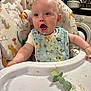 baby, high_chair, bib, food, messy, kitchen, infant, feeding, expression, face, mouth_open, clothing, plastic, utensil, toy, happy, person, child, indoor, seat