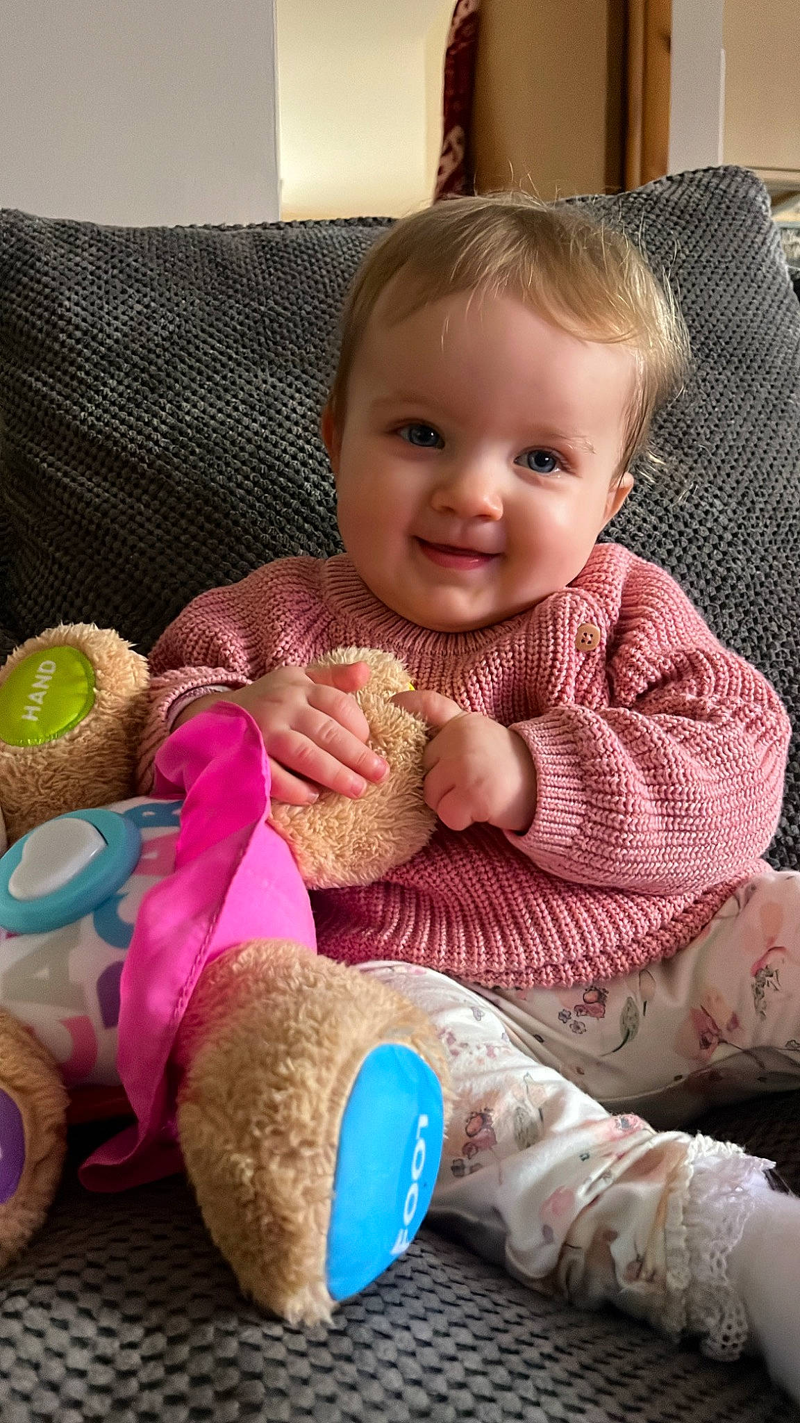 Darcie is registered to the contest to win money with this photo: baby, baby_toddler_clothing, cheek, child, comfort, couch, eye, finger, happy, head, iris, joy, lap, mammal, person, sitting, skin, sleeve, smile, thumb