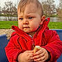 baby, blue_eyes, bread, child, coat, cute, expression, face, grass, hair, hands, nature, outdoor, park, pond, portrait, red_jacket, snack, toddler, winter_coat