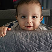 Quentin Maximus joined the competition — help win amazing prizes! baby, child, face, hands, playpen, quilted, curious, smile, indoor, person, infant, cute, expression, closeup, portrait, young, room, fabric, mesh, home