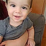 Quentin Maximus is registered to the contest to win money with this photo: toddler, child, smile, face, striped_shirt, arm, hand, indoor, couch, person, happy, skin, head, eyes, baby, holding, expression, seated, cute, young