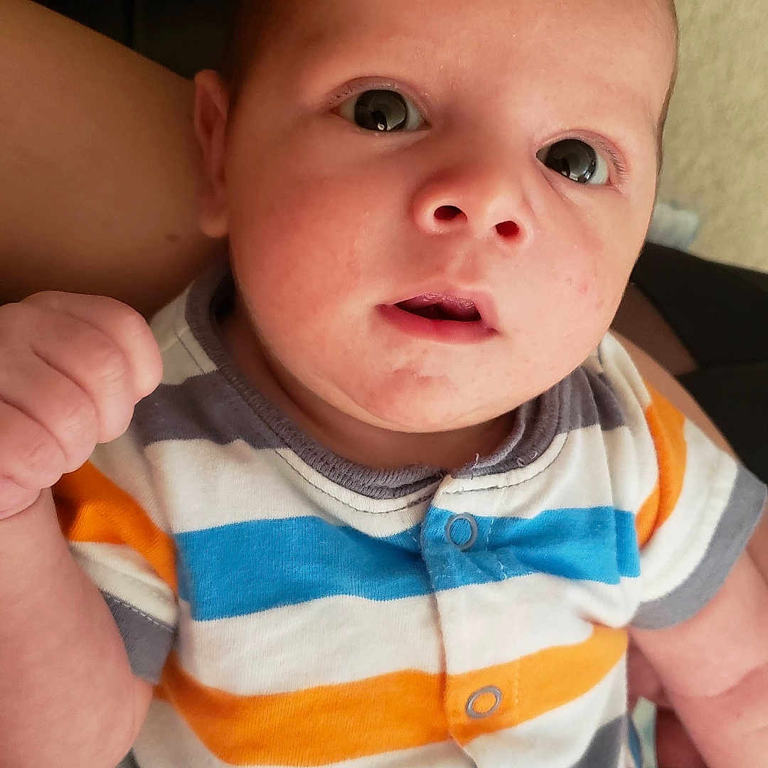 Quentin Maximus joined the competition — help win amazing prizes! baby, child, closeup, clothing, cute, expression, eyes, face, hand, holding, human, indoor, infant, newborn, onesie, person, portrait, skin, striped, young