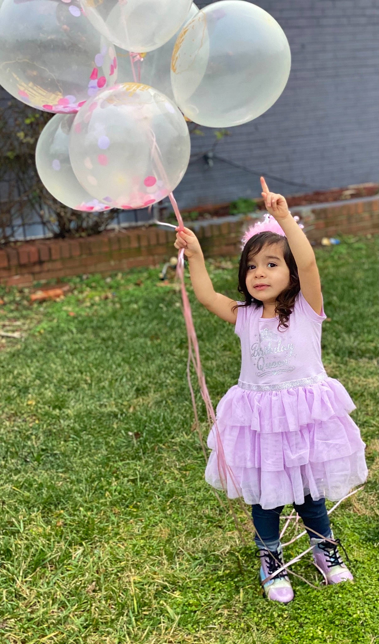 Khloe is registered to the contest to win money with this photo: balloon, botany, event, fun, grass, grassland, green, happy, lawn, leg, leisure, magenta, nature, party_supply, person, pink, plant, recreation, sandal, toddler