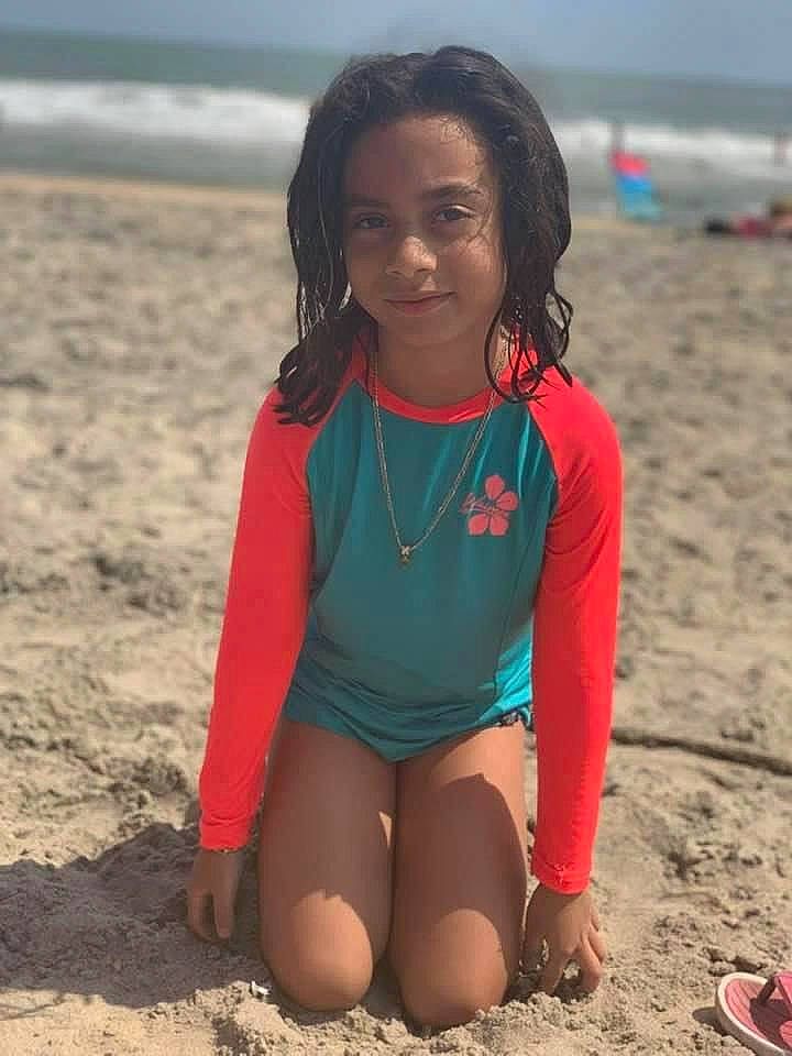 Kataleya is registered to the contest to win money with this photo: arm, beach, clothing, coastal_and_oceanic_landforms, facial_expression, fun, hair, happy, head, joy, outerwear, people_in_nature, people_on_beach, person, sky, sportswear, summer, swimwear, t_shirt, thigh