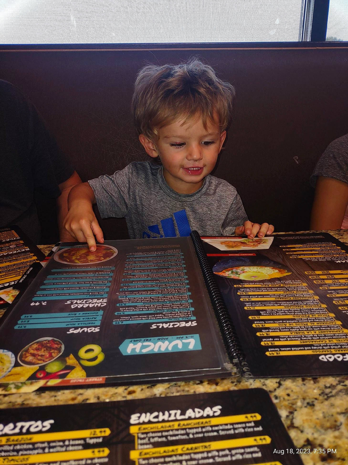 Jesse is registered to the contest to win money with this photo: audio_equipment, chair, child, cooking, electronic_instrument, electronic_musical_instrument, fun, gadget, games, indoor_games_and_sports, person, play, publication, recreation, room, sharing, smile, t_shirt, table, tabletop_game