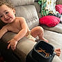 Luka joined the competition — help win amazing prizes! toddler, child, smiling, diaper, couch, blanket, pillow, pretzel, snack_holder, indoors, living_room, happy, curly_hair, bare_chest, furniture, relaxing, cute, playful, home, person