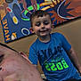 child, boy, smile, portrait, blue_shirt, adult, pout, chain, burger_king, mural, fries, dancing_silhouettes, colorful, indoor, wall_art, casual, happy, person, food_art, restaurant