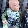 Rhett is registered to the contest to win money with this photo: apparel, baby, bib, blue_eyes, car_seat, child, clothing, curious, cute, face, hands, head, indoor, infant, person, portrait, seatbelt, sitting, stroller, young_child
