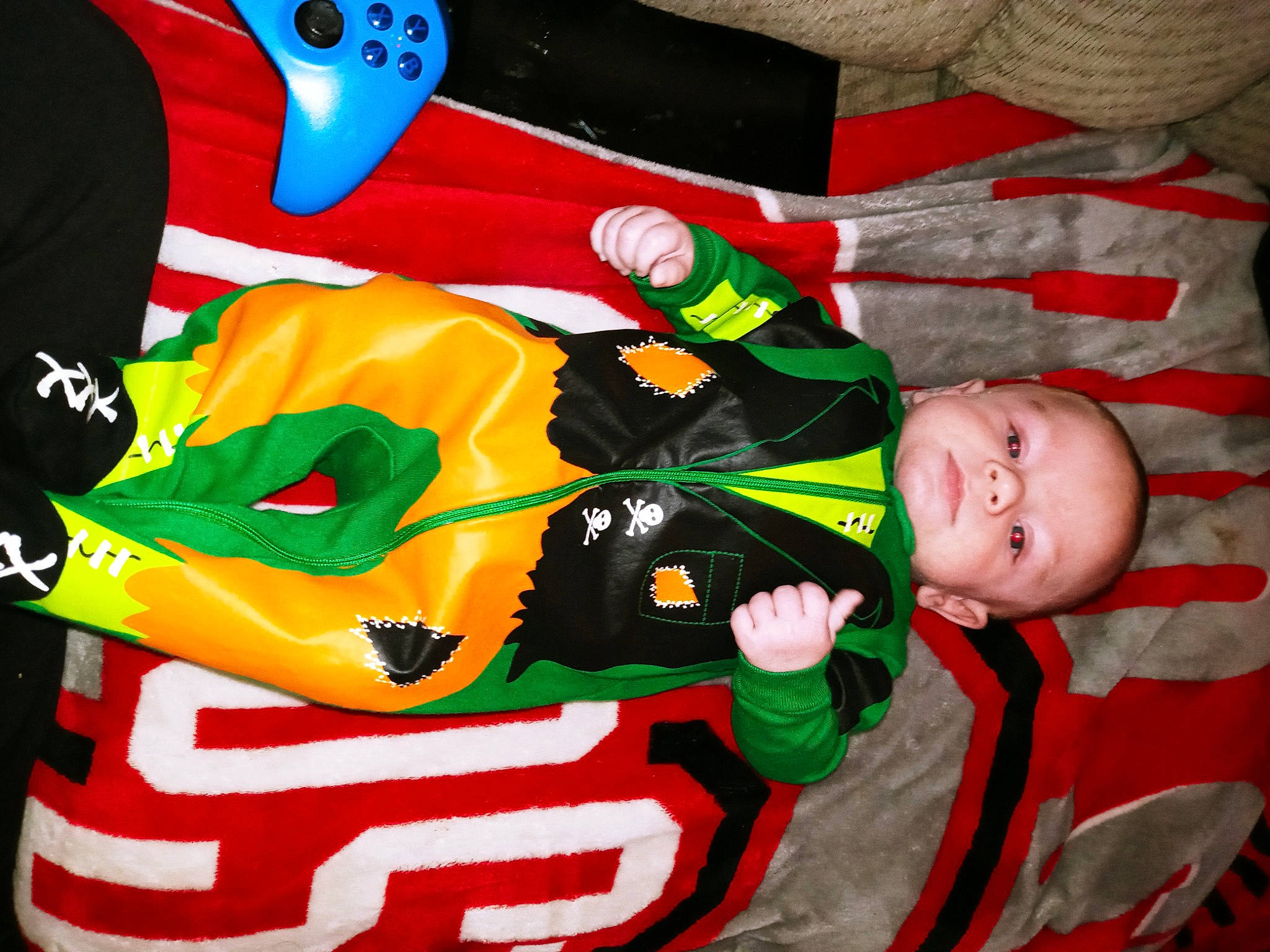 Ryder is registered to the contest to win money with this photo: baby, baby_toddler_clothing, carmine, child, christmas, christmas_eve, event, fictional_character, flag, gesture, green, happy, holiday, person, red, room, sleeve, toddler, tree