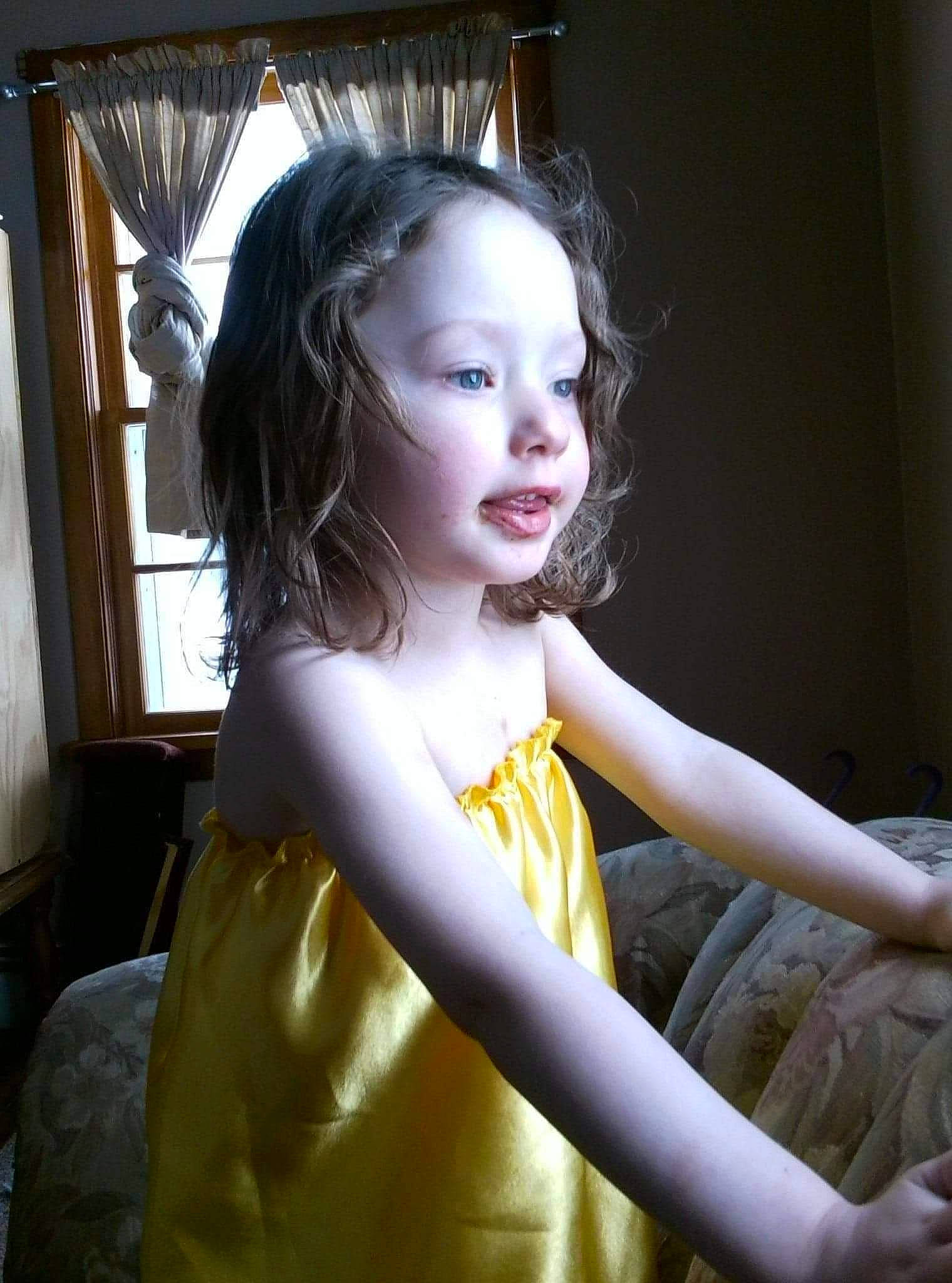 Emilee is registered to the contest to win money with this photo: black_hair, blond, brown_hair, day_dress, dress, eye, fashion_design, flash_photography, hair, head, human_body, human_leg, iris, lip, long_hair, one_piece_garment, person, skin, thigh, toddler