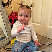 Arabelle joined the competition — help win amazing prizes! toddler, child, pigtails, blue_eyes, white_shirt, denim_pants, sitting, carpet, mirror, hairbrush, lotion_bottle, makeup_brush, indoor, cute, smiling, playful, person, floor, reflection, curious