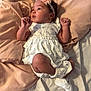 accessories, baby, bed, blanket, bodypart, bonnet, clothing, cushion, dress, face, finger, furniture, hand, hat, head, homedecor, newborn, person, photography, portrait