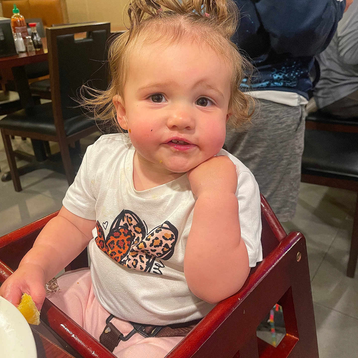 Sunshyne joined the competition — help win amazing prizes! toddler, child, high_chair, curly_hair, white_shirt, leopard_print, bow, restaurant, table, chair, food, casual, indoor, person, cute, expression, sitting, hand_on_face, pink_pants, hair_ties