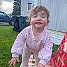 Sunshyne is registered to the contest to win money with this photo: toddler, child, outdoor, grass, bench, red_bench, pink_clothing, heart_pattern, smiling, playful, face, hands, barefoot, daylight, cloudy_sky, trash_bins, vehicle, mobile_home, person, young_child