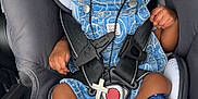 Kelvin is registered to the contest to win money with this photo: baby, car_seat, infant, blue_outfit, pacifier, sock, seatbelt, warning_label, child, straps, cute, indoor, sitting, head, person, clothing, portrait, accessory, baby_accessory, curly_hair
