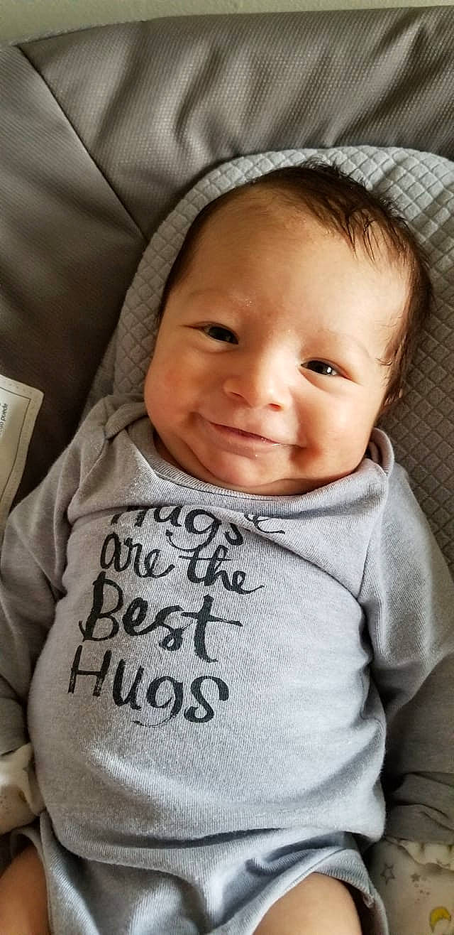 Nikolas is registered to the contest to win money with this photo: baby, baby_products, cheek, child, cool, face, facial_expression, forehead, happy, head, hoodie, nose, outerwear, person, product, skin, sleeve, smile, t_shirt, toddler