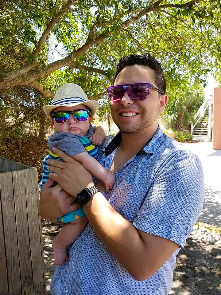 Nikolas is registered to the contest to win money with this photo: botany, fun, glasses, headwear, joy, person, photography, smile, tree, vacation