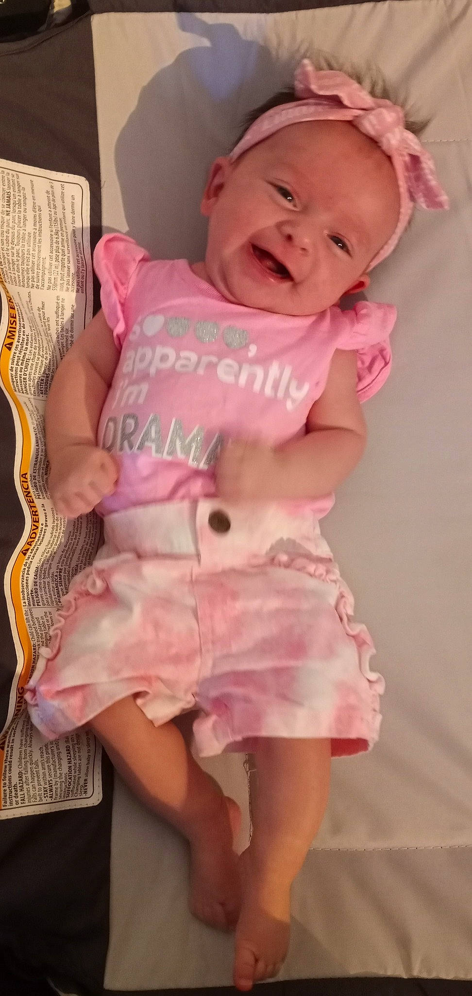 Liliana is registered to the contest to win money with this photo: baby, baby_products, baby_safety, baby_sleeping, baby_toddler_clothing, cheek, happy, infant_bed, linens, lip, magenta, neck, pattern, person, pink, skin, sleeve, smile, t_shirt, textile