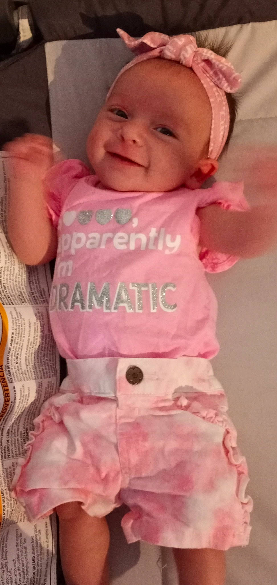 Liliana is registered to the contest to win money with this photo: baby, baby_toddler_clothing, cheek, chin, eyebrow, face, happy, iris, joy, lip, mouth, neck, nose, person, pink, skin, sleeve, smile, standing, t_shirt