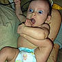 Maya is registered to the contest to win money with this photo: baby, diaper, foot, hand, arms, cable, couch, blanket, person, skin, expression, wide_eyes, indoors, holding, sitting, cute, infant, home, relaxed, barefoot