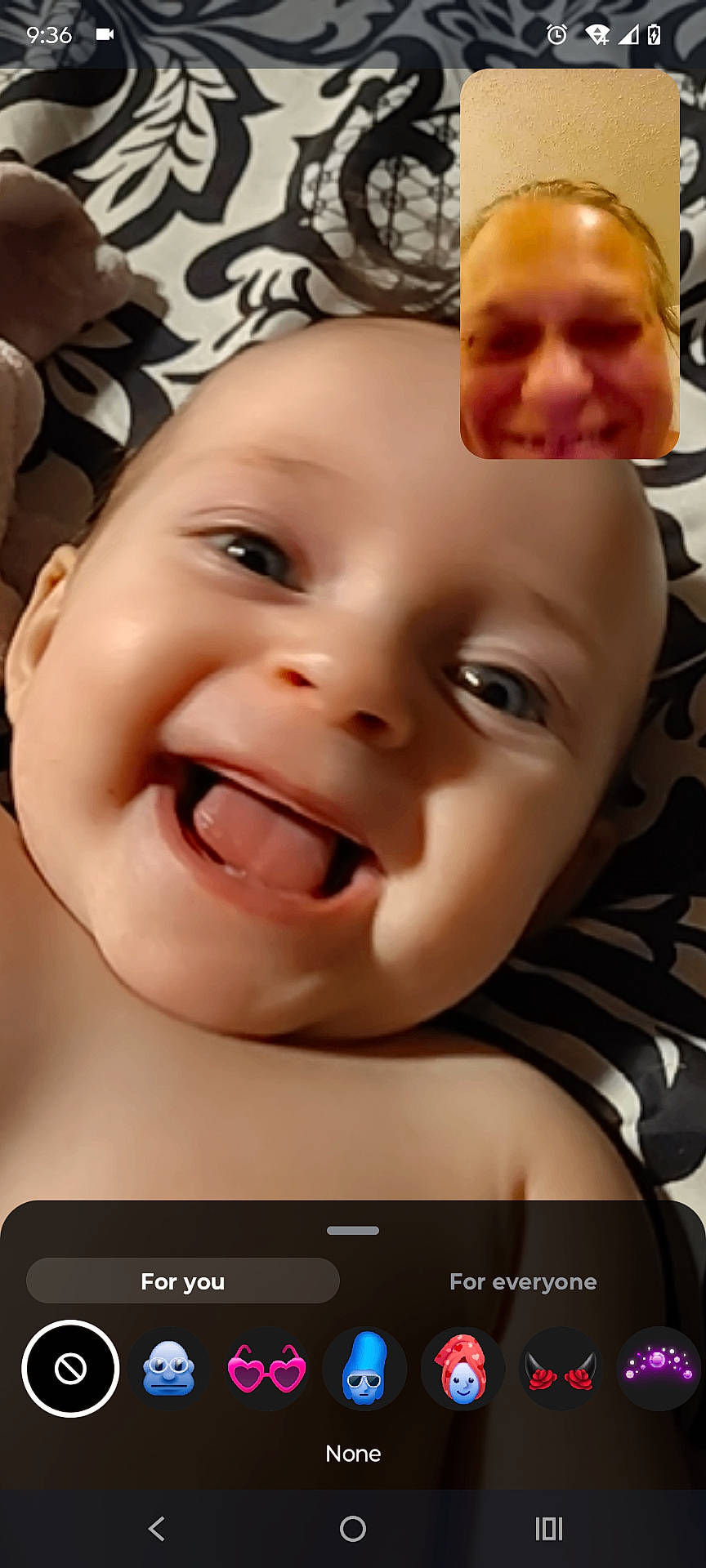 Maya joined the competition — help win amazing prizes! adult, app_icons, baby, blanket, closeup, expression, face, happy, head, indoors, infant, pattern, person, phone, portrait, screen, skin, smiling, tongue_out, video_call