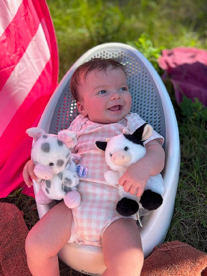 Laikyn is registered to the contest to win money with this photo: baby, baby_products, baby_toddler_clothing, child, companion_dog, doll, fawn, grass, happy, lap, leisure, person, pink, product, sitting, skin, stuffed_toy, teddy_bear, thigh, toddler