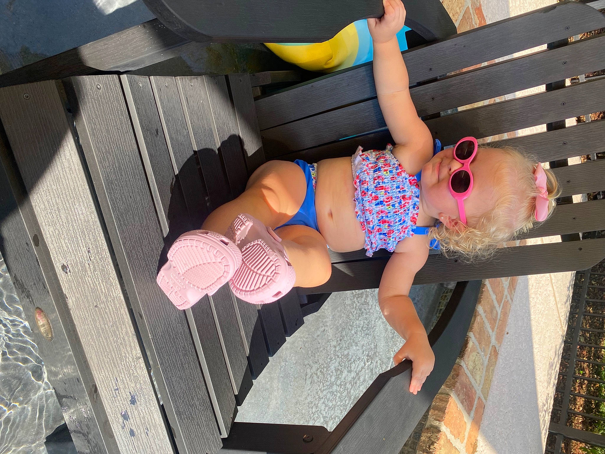 Marleigh joined the competition — help win amazing prizes! barefoot, brassiere, child, foot, fun, hat, human_leg, knee, leg, leisure, pattern, person, pink, sandal, shorts, sitting, swimwear, thigh, toddler, vehicle_door