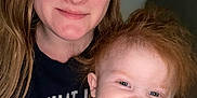 Hope is registered to the contest to win money with this photo: woman, child, toddler, smiling, red_hair, indoor, portrait, face, person, happy, casual_clothing, closeup, family, cute, light_skin, young_child, mother_and_child, human, head_and_shoulders, friendly