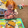 Hope is registered to the contest to win money with this photo: bed, bluey, breakfast, carpet, cereal, child, furniture, indoor, pajamas, person, plate, red_hair, room, smile, stuffed_animal, table, toddler, toys, unicorn, waffles