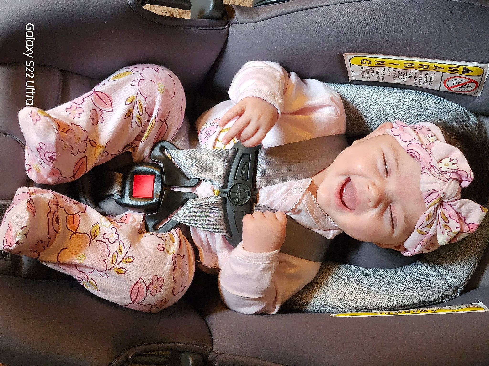 Lydia is registered to the contest to win money with this photo: arm, car_seat, child, comfort, cool, fashion, fashion_accessory, finger, hand, headwear, human_leg, knee, linens, nail, person, pink, product, sitting, skin, thigh