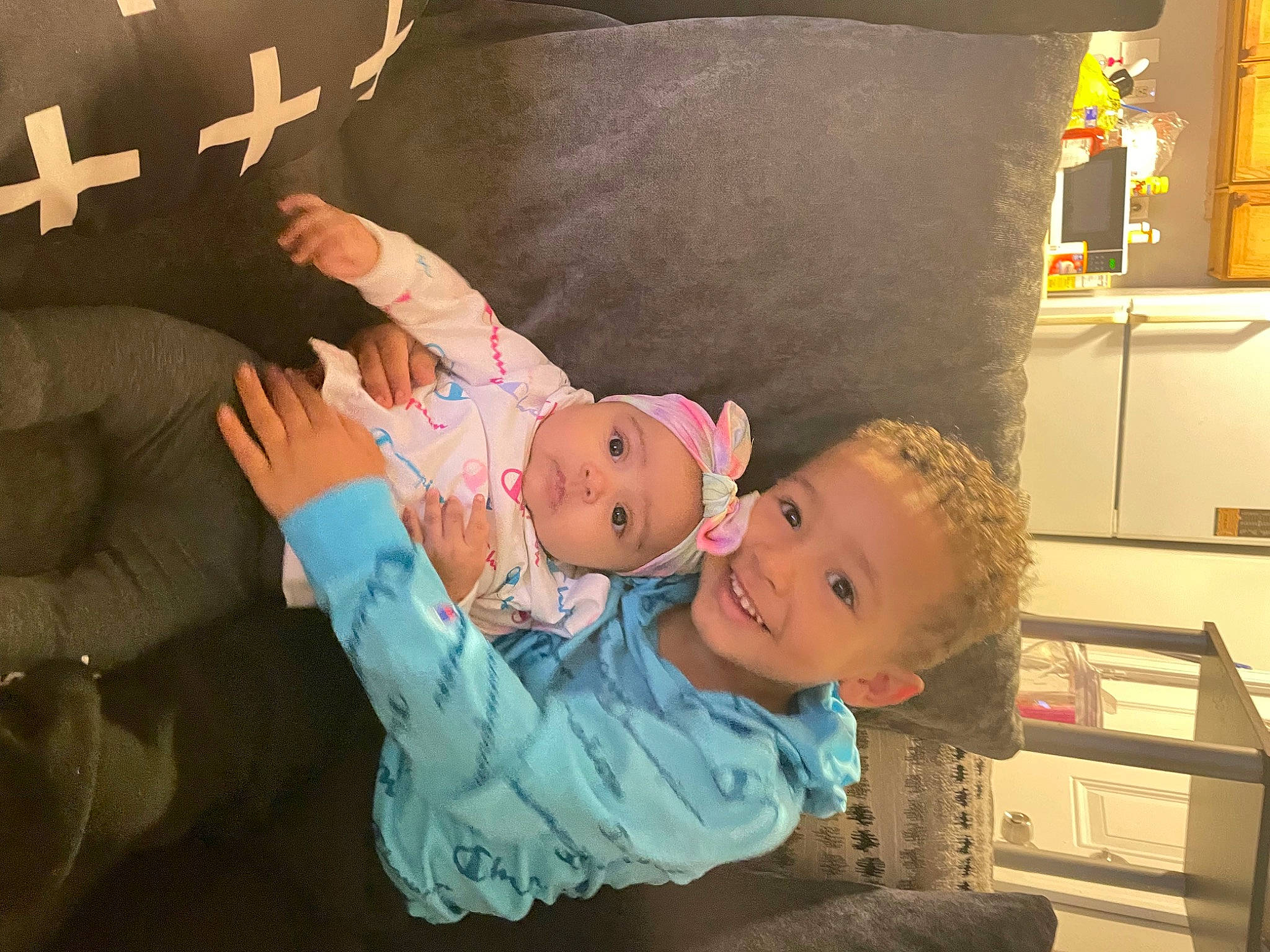 Rylan joined the competition — help win amazing prizes! baby, baby_products, baby_toddler_clothing, cabinetry, cheek, chest_of_drawers, child, comfort, cupboard, drawer, happy, hat, headwear, joy, lap, person, picture_frame, refrigerator, room, shelf