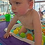 Raphaël participe au concours pour gagner de l'argent avec cette photo : arm, baby, background_people, ball_pit, bucket, child, close_up, colorful_balls, face, hands, indoor_pool, plastic_balls, play, pool, splash, swimwear, toddler, tray, water, wet_hair