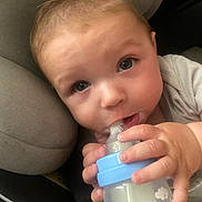 Lironn participe au concours pour gagner de l'argent avec cette photo : baby, child, milk_bottle, drinking, blue_eyes, close_up, cute, cushion, soft, hand, infant, face, feeding, comfort, indoors, young_child, person, portrait, warm, casual