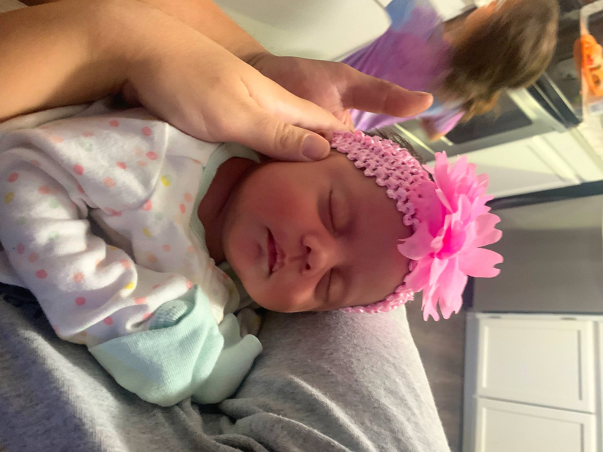 Abigail is registered to the contest to win money with this photo: abdomen, baby, baby_toddler_clothing, chest, child, comfort, elbow, eyelash, finger, flower, headpiece, headwear, lip, magenta, nail, nose, person, petal, pink, room