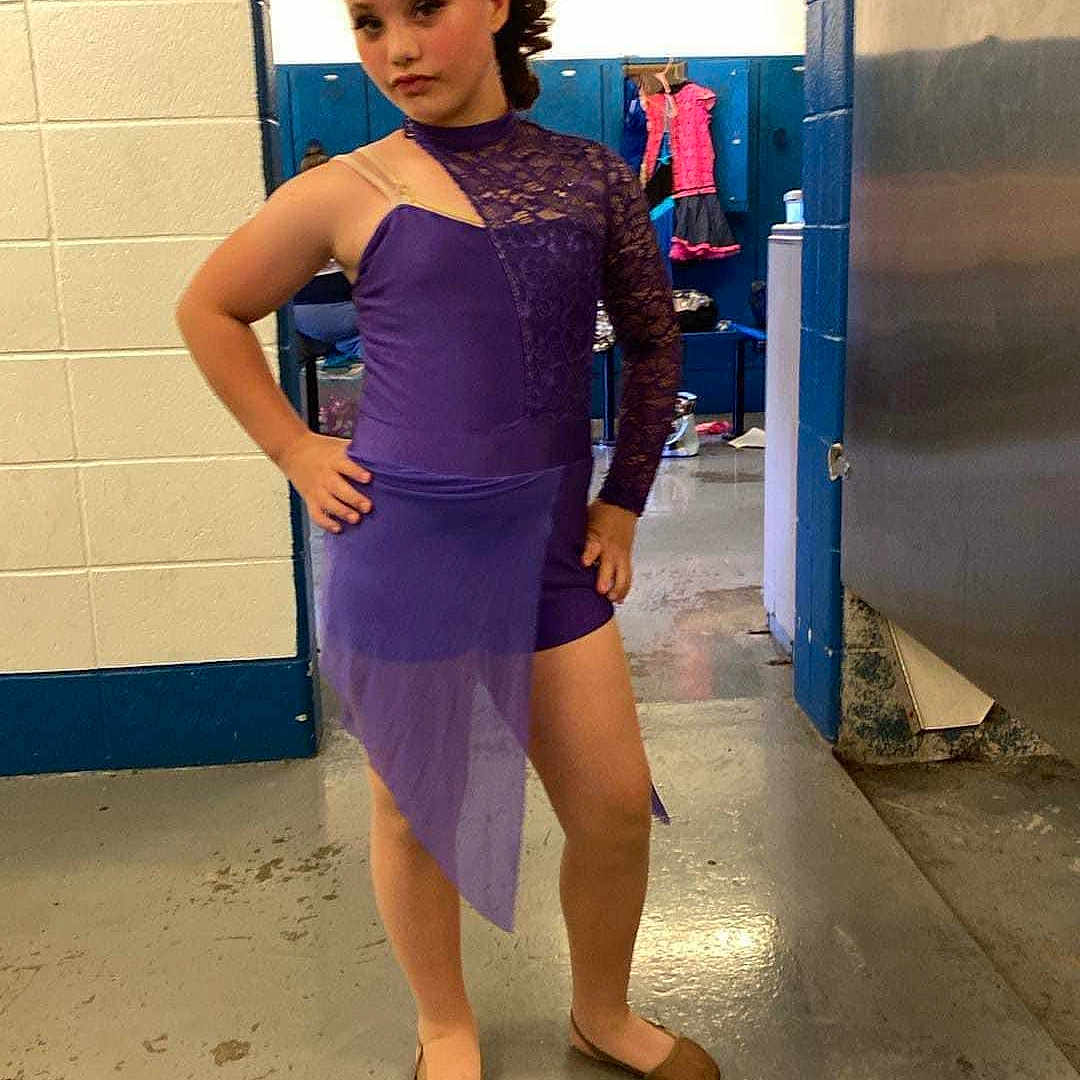 Zoey is registered to the contest to win money with this photo: accessories, adult, clothing, costume, dress, eveningdress, face, female, footwear, formalwear, head, indoors, person, photography, portrait, sandal, shoe, sleeve, standing, woman