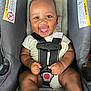 baby, car_seat, smiling, infant, happiness, child, clothing, safety_harness, cute, indoor, person, seat, strap, footwear, closeup, warning_label, young_child, expression, joy, skin