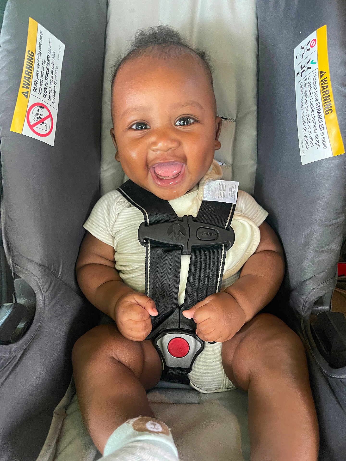 Zayden joined the competition — help win amazing prizes! baby, car_seat, smiling, infant, happiness, child, clothing, safety_harness, cute, indoor, person, seat, strap, footwear, closeup, warning_label, young_child, expression, joy, skin