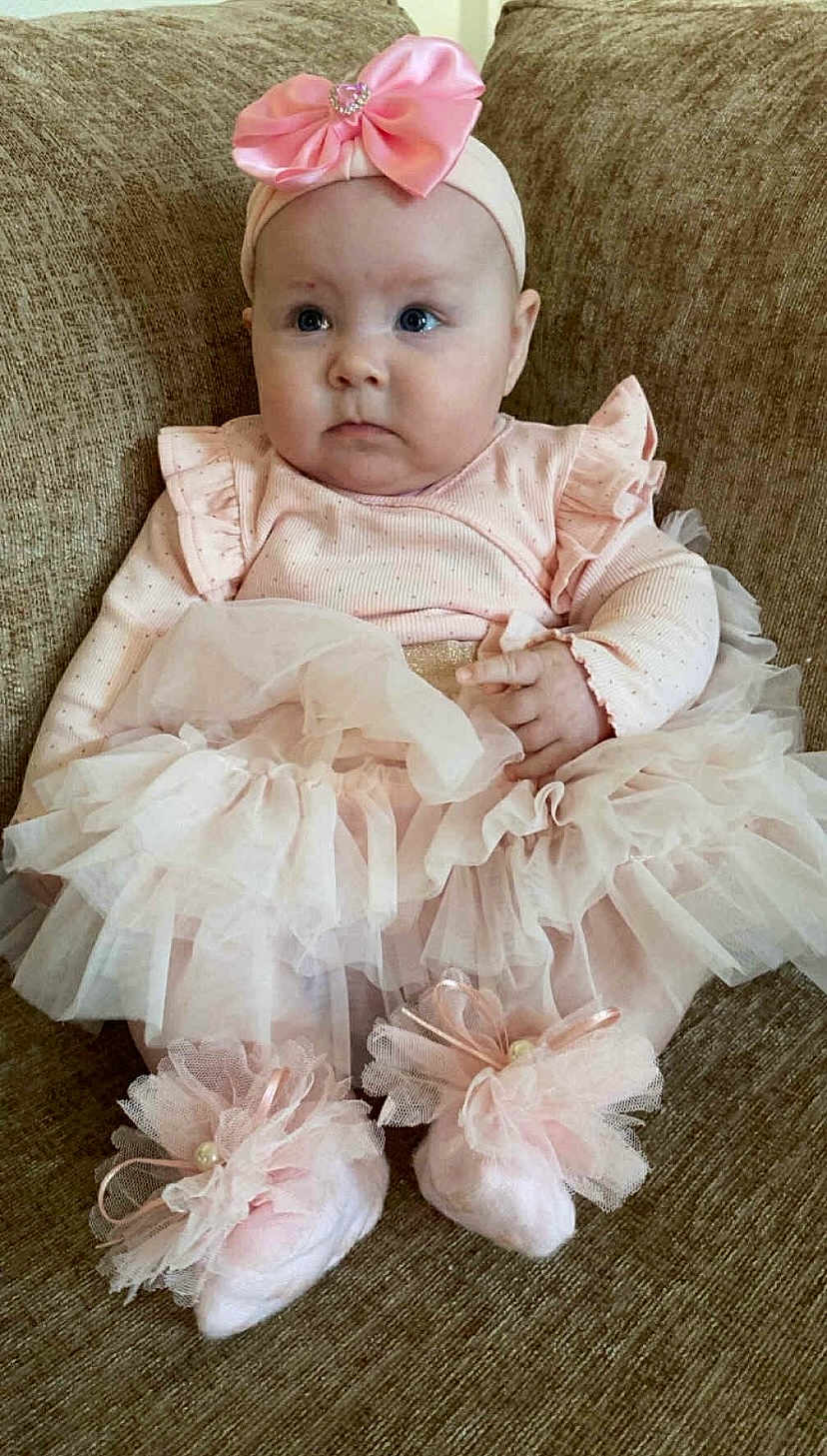 Ariana Maeve joined the competition — help win amazing prizes! baby, infant, pink_bow, headband, tutu, dress, sitting, couch, child, cute, soft_toys, footwear, ruffles, portrait, indoor, young_child, adorable, fashion, pretty, small