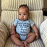 baby, infant, child, onesie, text, chair, plush, comfort, seated, cute, indoors, expression, skin, hands, feet, portrait, young, cozy, soft, casual