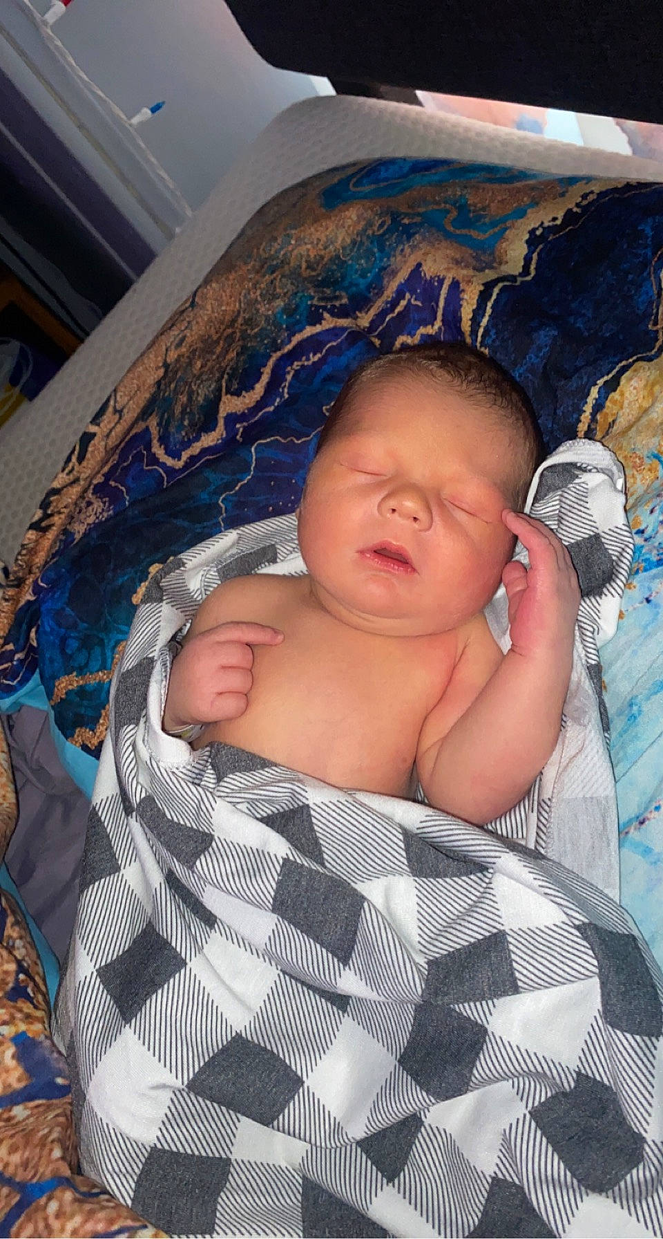 Cam is registered to the contest to win money with this photo: abdomen, baby, baby_products, baby_safety, baby_toddler_clothing, blue, cheek, chest, child, clock, comfort, fun, infant_bed, linens, mouth, pattern, person, sitting, thumb, toddler