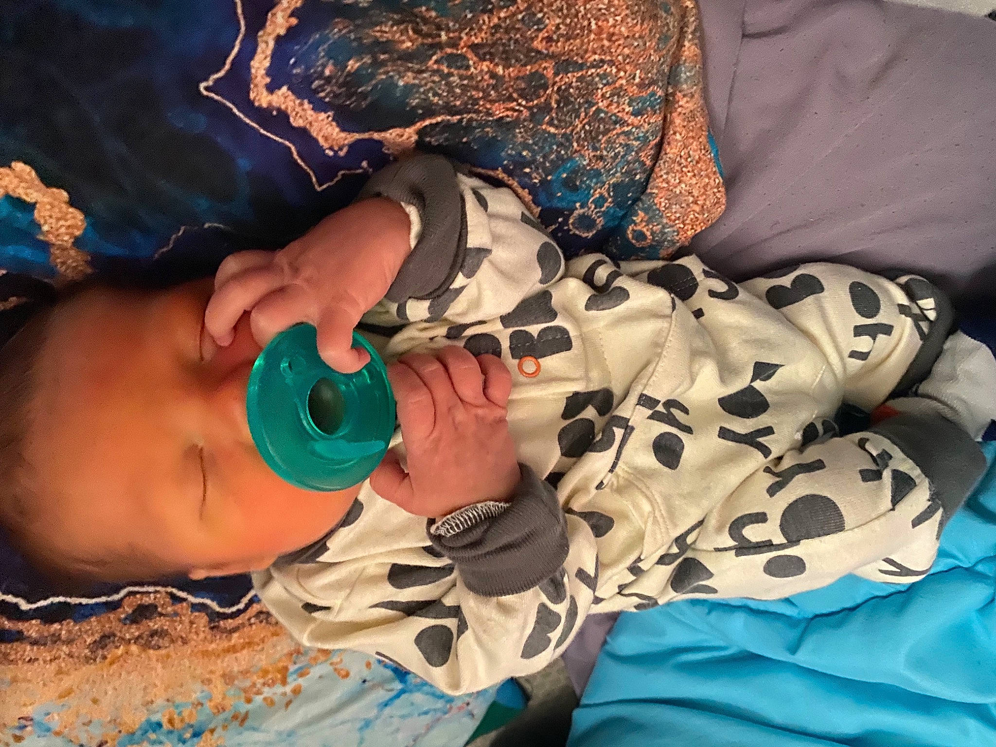 Cam is registered to the contest to win money with this photo: arm, baby, child, comfort, cool, drinkware, eyelash, eyewear, finger, hand, happy, human_body, mouth, nail, neck, pattern, person, skin, sleeve, textile