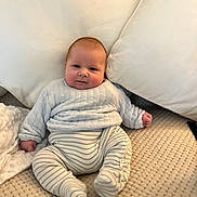 Albie is registered to the contest to win money with this photo: baby, blanket, child, comfort, cozy, cushion, cute, face, footed_pants, homedecor, indoor, infant, plush, portrait, quilted_sweater, sitting, smile, soft_texture, striped_clothing, young_child