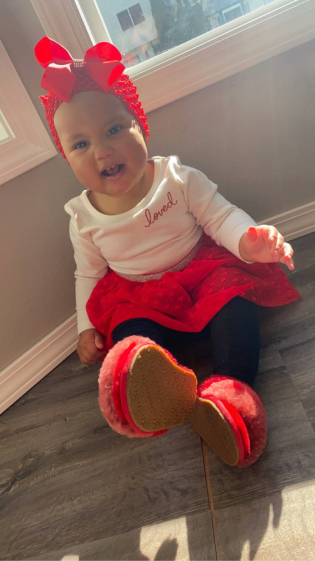 Estella joined the competition — help win amazing prizes! baby, baby_toddler_clothing, child, costume_hat, event, floor, flooring, foot, happy, hardwood, headgear, headwear, human_body, human_leg, knee, person, sleeve, smile, sock, thigh