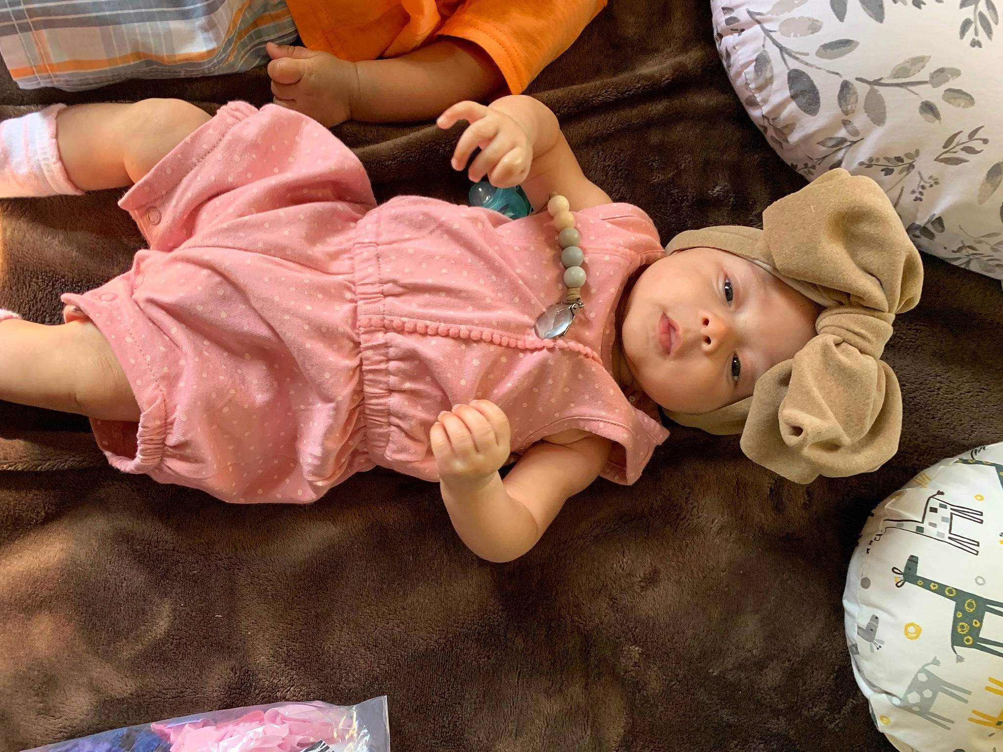 Reign is registered to the contest to win money with this photo: baby, baby_products, baby_toddler_clothing, bedtime, cheek, child, comfort, face, flooring, head, headwear, human_leg, linens, nap, person, room, sitting, sleep, thigh, toddler
